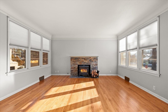 2828 S Arthur St, Spokane, WA 99203 - unfurnished living room featuring wood finished floors, baseboards, and a wood stove