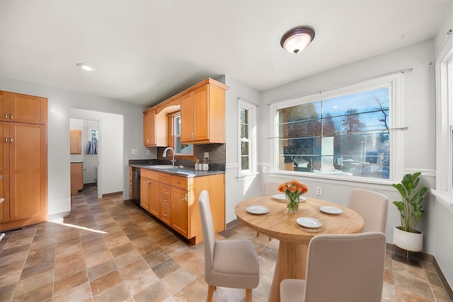 2828 S Arthur St, Spokane, WA 99203 - kitchen featuring stone finish flooring, a sink, baseboards, recessed lighting, and backsplash