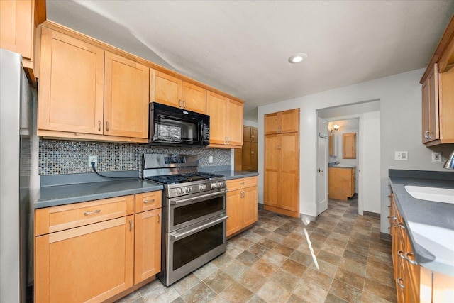 2828 S Arthur St, Spokane, WA 99203 - kitchen with black microwave, double oven range, freestanding refrigerator, a sink, and dark countertops