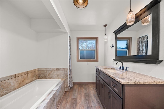 2828 S Arthur St, Spokane, WA 99203 - bathroom featuring vanity, a garden tub, baseboards, and wood finished floors