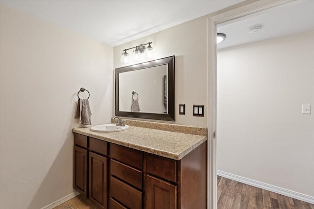 10503 E Valleyway Ave, Spokane Valley, WA 99206 - bathroom featuring vanity, baseboards, and wood finished floors