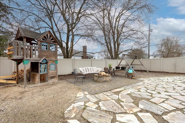 10503 E Valleyway Ave, Spokane Valley, WA 99206 - fenced backyard with an outdoor fire pit, a playground, and a patio area