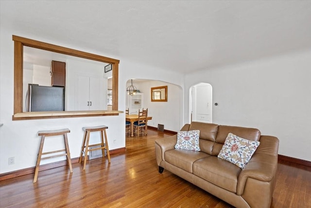 10503 E Valleyway Ave, Spokane Valley, WA 99206 - living room featuring arched walkways, wood finished floors, and baseboards