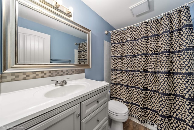4116 W Indian Trail Rd, Spokane, WA 99208 - full bath featuring vanity, toilet, decorative backsplash, wood finished floors, and a shower with curtain