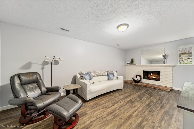 4116 W Indian Trail Rd, Spokane, WA 99208 - living area featuring wood finished floors, a fireplace, baseboards, and a textured ceiling
