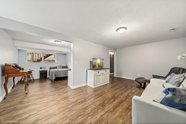4116 W Indian Trail Rd, Spokane, WA 99208 - living area featuring dark wood-style floors, a textured ceiling, and baseboards
