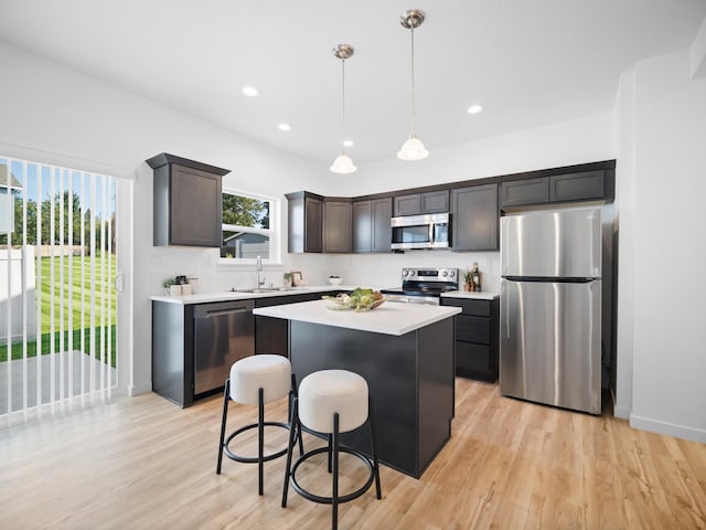 805 E F St, Deer Park, WA 99006 - kitchen with appliances with stainless steel finishes, a sink, light countertops, a kitchen island, and light wood-type flooring