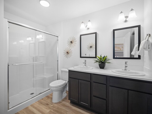 805 E F St, Deer Park, WA 99006 - full bathroom with double vanity, wood finished floors, a stall shower, and toilet