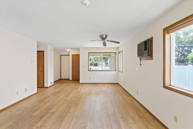 11103 E Main Ave, Spokane Valley, WA 99206 - spare room featuring an AC wall unit, a ceiling fan, light wood-style flooring, baseboards, and a smoke detector