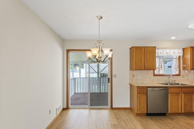 11103 E Main Ave, Spokane Valley, WA 99206 - kitchen with dishwasher, a sink, a chandelier, brown cabinetry, and light wood-type flooring