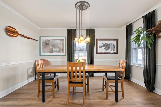 704 E 20th Ave, Spokane, WA 99203 - dining room featuring a chandelier, crown molding, wood finished floors, and baseboards