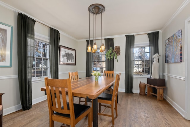 704 E 20th Ave, Spokane, WA 99203 - dining space with light wood-type flooring, a chandelier, crown molding, and baseboards