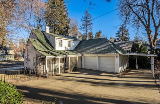 704 E 20th Ave, Spokane, WA 99203 - traditional-style house featuring a chimney, concrete driveway, and an attached garage