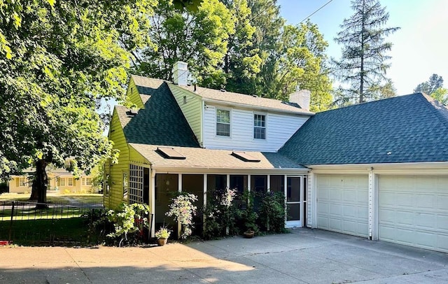 704 E 20th Ave, Spokane, WA 99203 - view of front of home featuring concrete driveway, a garage, a chimney, and a shingled roof