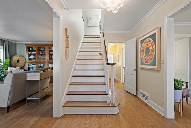 704 E 20th Ave, Spokane, WA 99203 - stairs featuring wood finished floors, crown molding, baseboards, and a chandelier