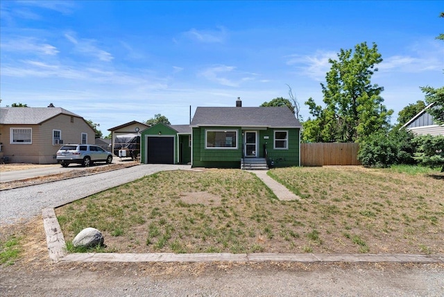 1403 N Farr Rd, Spokane, WA 99206 - view of front of property with an attached garage, gravel driveway, a chimney, and roof with shingles