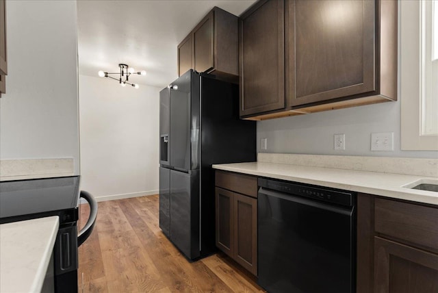 1403 N Farr Rd, Spokane, WA 99206 - kitchen featuring black appliances, dark brown cabinetry, light wood-type flooring, and light countertops