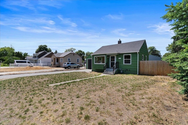 1403 N Farr Rd, Spokane, WA 99206 - view of front of house featuring a chimney, driveway, and roof with shingles