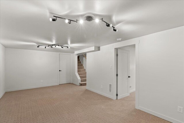 1403 N Farr Rd, Spokane, WA 99206 - finished below grade area with track lighting, light colored carpet, stairway, and baseboards