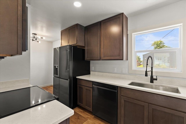1403 N Farr Rd, Spokane, WA 99206 - kitchen featuring dishwasher, a sink, refrigerator with ice dispenser, light wood-style flooring, and light countertops