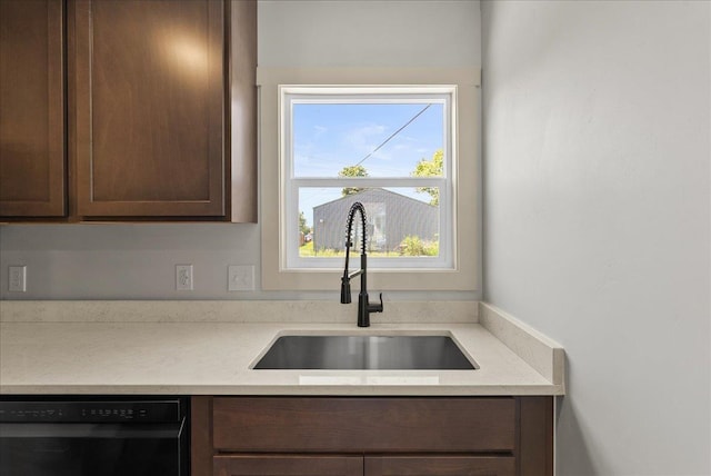 1403 N Farr Rd, Spokane, WA 99206 - kitchen with a sink, dishwasher, light countertops, and dark brown cabinetry