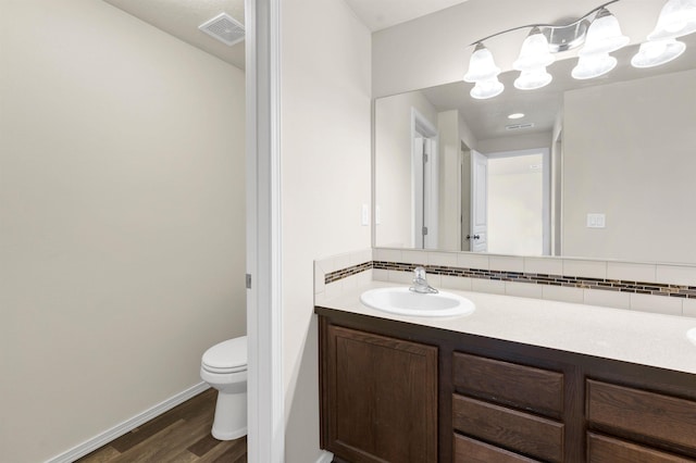 822 S Oswald St, Spokane, WA 99224 - bathroom with toilet, decorative backsplash, wood finished floors, and vanity