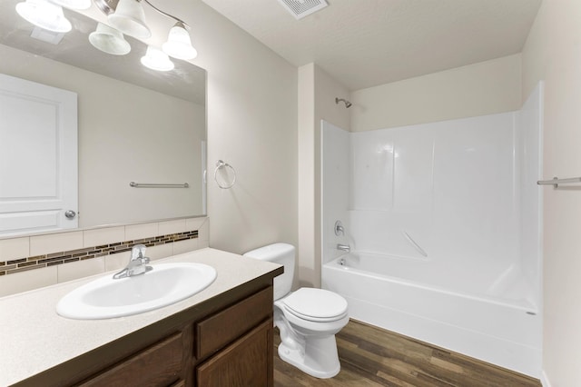 822 S Oswald St, Spokane, WA 99224 - full bath featuring wood finished floors, backsplash, vanity, toilet, and bathing tub / shower combination