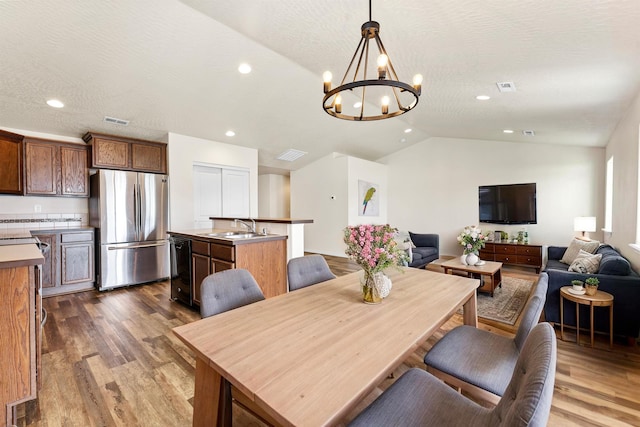 822 S Oswald St, Spokane, WA 99224 - dining space featuring lofted ceiling, wood finished floors, a chandelier, and recessed lighting