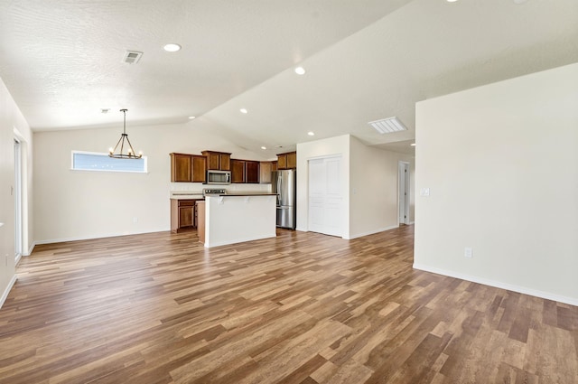 822 S Oswald St, Spokane, WA 99224 - unfurnished living room featuring lofted ceiling, light wood-style flooring, a chandelier, recessed lighting, and baseboards