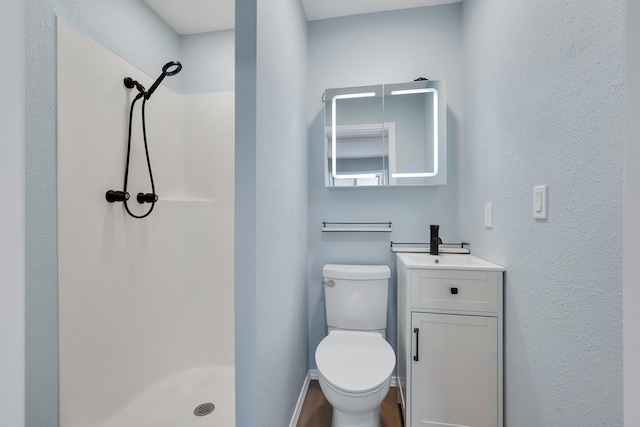 28600 N Mt Spokane Park Dr Unit 603, Mead, WA 99021 - full bath featuring a shower stall, vanity, toilet, baseboards, and a textured wall
