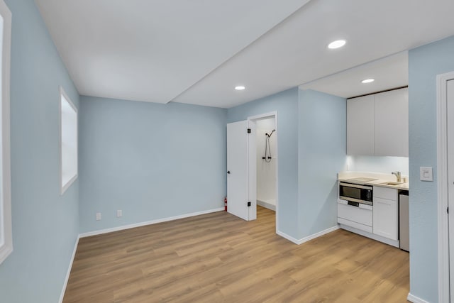 28600 N Mt Spokane Park Dr Unit 603, Mead, WA 99021 - empty room with light wood-style flooring, baseboards, a sink, and recessed lighting
