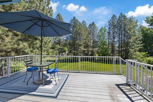 4510 E Bixel Ct, Mead, WA 99021 - wooden deck featuring outdoor dining space, a lawn, and view of wooded area