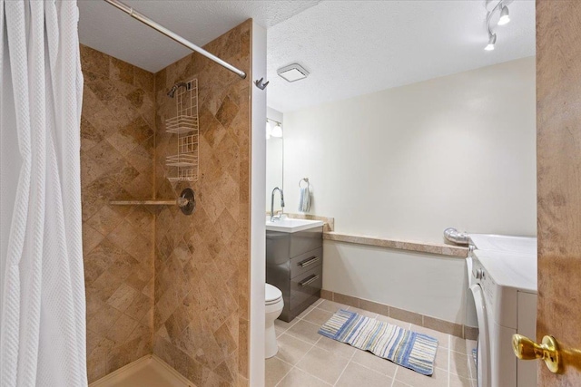 4510 E Bixel Ct, Mead, WA 99021 - full bath with vanity, independent washer and dryer, toilet, tile patterned flooring, and tiled shower