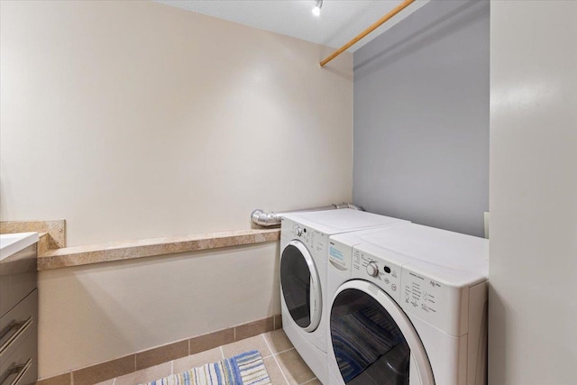 4510 E Bixel Ct, Mead, WA 99021 - laundry area with washing machine and dryer, light tile patterned floors, and baseboards