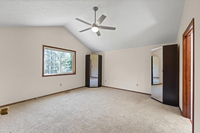 4510 E Bixel Ct, Mead, WA 99021 - unfurnished bedroom featuring light colored carpet, lofted ceiling, baseboards, and ceiling fan