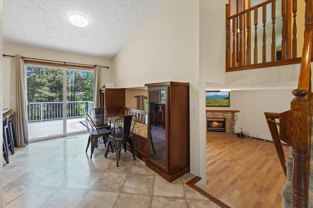 4510 E Bixel Ct, Mead, WA 99021 - dining area with a textured ceiling, a fireplace, and high vaulted ceiling