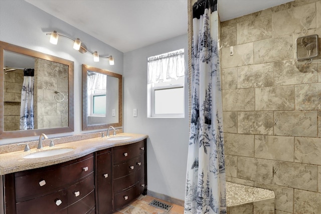 7312 E Euclid Ave, Spokane Valley, WA 99212 - full bathroom with double vanity, tiled shower, and baseboards