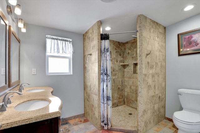 7312 E Euclid Ave, Spokane Valley, WA 99212 - full bath featuring toilet, tiled shower, double vanity, baseboards, and recessed lighting