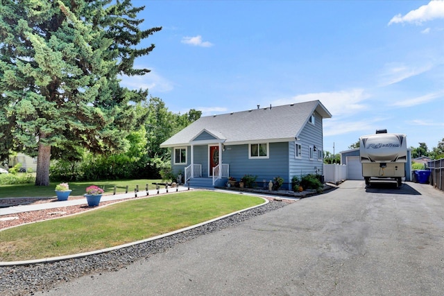 7312 E Euclid Ave, Spokane Valley, WA 99212 - bungalow with an outdoor structure, asphalt driveway, a front lawn, a garage, and a shingled roof