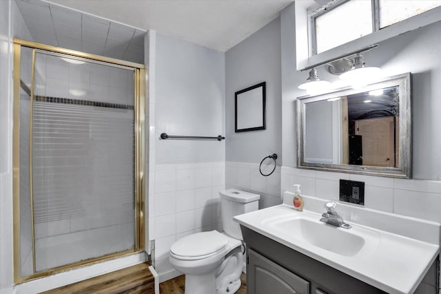 7312 E Euclid Ave, Spokane Valley, WA 99212 - full bath with tile walls, vanity, a stall shower, toilet, and wood finished floors