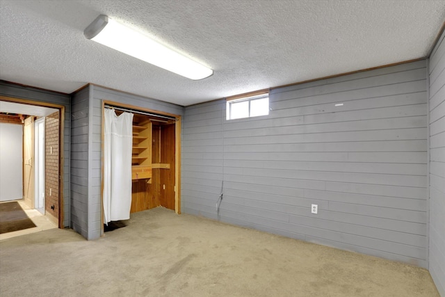 7312 E Euclid Ave, Spokane Valley, WA 99212 - unfurnished bedroom with carpet, wooden walls, a textured ceiling, and a closet