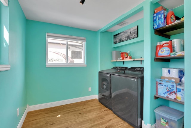 7312 E Euclid Ave, Spokane Valley, WA 99212 - laundry area with washer and clothes dryer, wood finished floors, and baseboards
