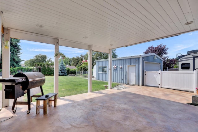 7312 E Euclid Ave, Spokane Valley, WA 99212 - view of patio / terrace featuring a garage, a gate, an outdoor structure, area for grilling, and driveway