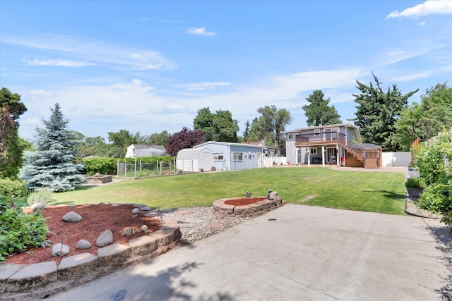 7312 E Euclid Ave, Spokane Valley, WA 99212 - view of yard with a deck, a patio area, an outdoor structure, and a fire pit
