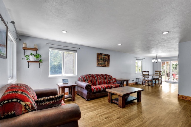 7312 E Euclid Ave, Spokane Valley, WA 99212 - living room featuring a chandelier, a textured ceiling, wood finished floors, recessed lighting, and baseboards