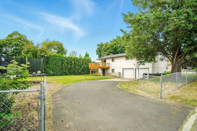 14018 E Valleyway Ave, Spokane, WA 99216 - view of front facade featuring driveway, a garage, a gate, a deck, and a chimney
