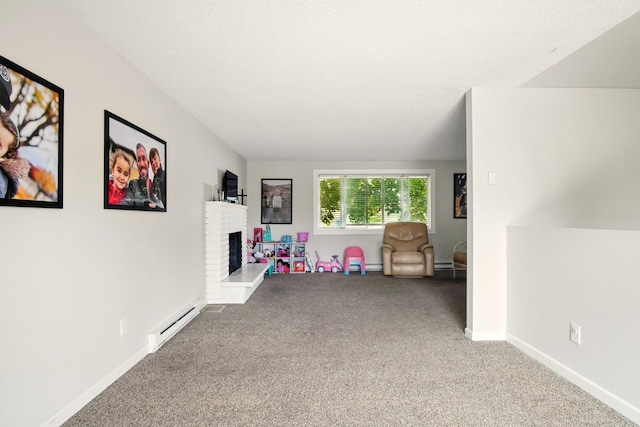 14018 E Valleyway Ave, Spokane, WA 99216 - recreation room featuring a baseboard radiator, carpet floors, and a fireplace