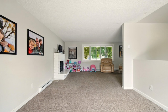 14018 E Valleyway Ave, Spokane, WA 99216 - playroom featuring a baseboard heating unit, carpet, a fireplace, baseboards, and a textured ceiling