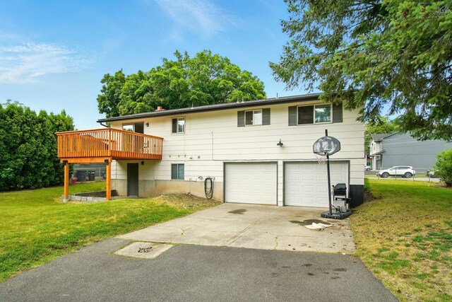 14018 E Valleyway Ave, Spokane, WA 99216 - view of front of property with a garage, concrete driveway, a front lawn, and a deck