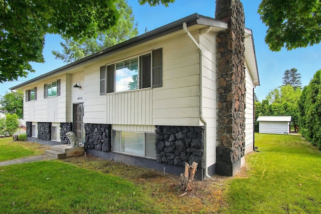 14018 E Valleyway Ave, Spokane, WA 99216 - bi-level home featuring a chimney, stone siding, and a front yard
